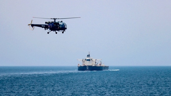 An Indian Navy Chetak helicopter carries out aerial security patrols above a commercial crude oil tanker navigating through the Bab-el-Mandeb strait, between the Red Sea and the Gulf of Aden.