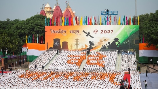 Children stand in a formation that reads "Vande Mataram" during the Independence Day celebrations at Red Fort.