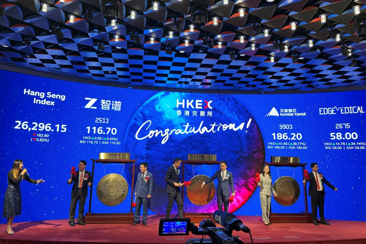 Executives at Tang’s Z.AI—then known as Knowledge Atlas Technology, or Zhipu—struck a gong, left, at the Hong Kong stock exchange in January. Executives at Tang’s Z.AI—then known as Knowledge Atlas Technology, or Zhipu—struck a gong, left, at the Hong Kong stock exchange in January.