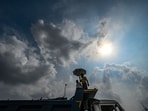 Gram it: A man walks under dark monsoon clouds along the Ashram Road in Delhi, on Saturday. The Delhi Traffic Police (DTP) has issued an advisory stating traffic movement is likely to be affected at Ashram-Kilokari stretch, till August 28. This is due to the ongoing renovation work being carried by Delhi Jal Board.(Photo: RAJ K RAJ/HT)