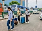 Passengers drag their luggage after Qaumi Insaaf Morcha supporters blocked movement of buses at the Patiala bus stand. (PTI)