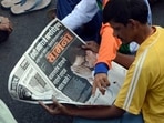 Shiv-Sena-supporters-read-the-party-s-official-newspaper-Saamna-with-the-front-page-news-of-the-demise-of-Shiv-Sena--chief-Bal-Thackeray-during-his-funeral-procession-in-Mumbai-AFP-Photo