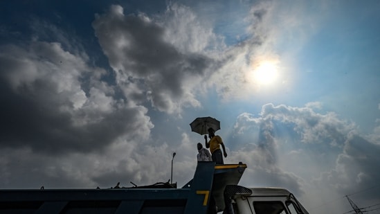 Gram it: A man walks under dark monsoon clouds along the Ashram Road in Delhi, on Saturday. The Delhi Traffic Police (DTP) has issued an advisory stating traffic movement is likely to be affected at Ashram-Kilokari stretch, till August 28. This is due to the ongoing renovation work being carried by Delhi Jal Board.