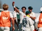 Mitchell Starc (C) celebrates with teammates after taking his tenth wicket for the match of Bangladesh's Taijul Islam during the second day of the second Test match