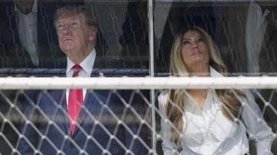 Donald Trump and first lady Melania Trump attend the IndyCar Freedom 250 Grand Prix auto race in Washington DC on Sunday. (AP) Donald Trump and first lady Melania Trump attend the IndyCar Freedom 250 Grand Prix auto race in Washington DC on Sunday. (AP)