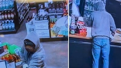 The masked suspect was seen on CCTV wearing a grey hoodie, jeans and black work-style boots (City of Jackson, TN - Police Department/Facebook) The masked suspect was seen on CCTV wearing a grey hoodie, jeans and black work-style boots (City of Jackson, TN - Police Department/Facebook)