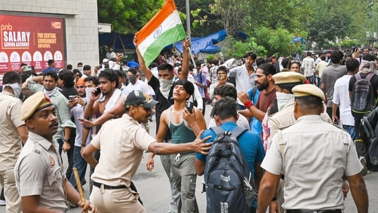 Delhi Police carry out a lathi-charge to disperse supporters of the Cockroach Janta Party (CJP) after they gather in large numbers and breach security barricades near Parliament House on DR Rajendra Prasad Road in New Delhi, India, on Monday, July 20, 2026. 