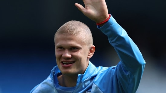 Manchester City's Norwegian striker #09 Erling Haaland, sporting a new hair cut, warms up ahead of the English Premier League football match between Manchester City and AFC Bournemouth  at the Etihad Stadium in Manchester, north west England.