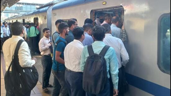 Mumbai, India - October 03, 2022: Scores of commuters stranded at the Borivali station as they had a harrowing time on Monday morning, the first day of revised air-conditioned local services on the Western line. Commuters struggle to board the packed AC local train on Monday at 7.45am from Borivali station. It was only after the police intervened and asked a few commuters to alight did the train move. (HT Photo) (Hindustan Times)