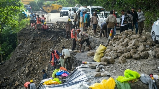 Workers carry out repair work on a damaged retaining wall along the Dehradun-Mussoorie road, at Paniwala Band, in Mussoorie, Uttarakhand, Saturday, Aug. 22, 2026.