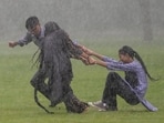 Students play near Kartavya Path amid monsoon showers, in New Delhi, Monday, Aug. 24, 2026. The weather office issued a red alert for heavy rain and a yellow alert for moderate rain across several districts, with thunderstorms, lightning and winds of 30-40 kmph also expected in parts of the city.