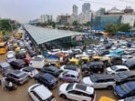 Vehicles remain stuck in a traffic jam on a waterlogged road following heavy rainfall, in Gurugram, Haryana, Monday