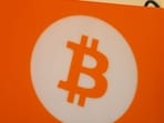 Strategy raises $2 billion and builds a $1.59 billion cash pool as Michael Saylor's firm pauses Bitcoin buying amid pressure on its financing model.(Photographer: Andrey Rudakov/Bloomberg)