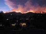 Smoke and flames rise from the Hawk fire in Reno, Nevada, U.S., August 22, 2026, in this screengrab from a video obtained from social media. (@SquintDev/via REUTERS)