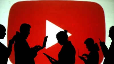 FILE PHOTO: Silhouettes of laptop and mobile device users are seen next to a screen projection of the YouTube logo in this picture illustration taken March 28, 2018.  REUTERS/Dado Ruvic/Illustration/File Photo (REUTERS)