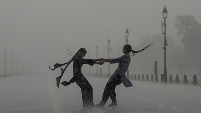 Gram it: Heavy monsoon showers kept Delhi on Red alert and the commuters battled traffic snarls for hours, on Monday. At Kartavya Path, however, some youngsters indulged in joie de vivre as they soaked up every moment of the downpour. Meanwhile, the India Meteorological Department (IMD) has issued a forecast of moderate rain and cloudy skies for today. (Photo: Arun Sharma/PTI)