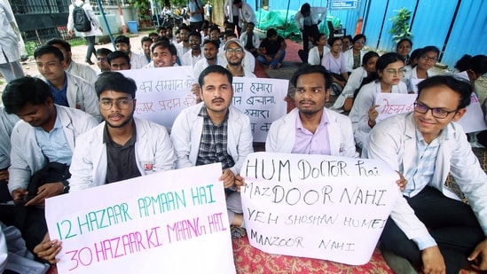 MBBS interns of King George's Medical University (KGMU) hold placards during a protest to demand an increase in their monthly internship stipend from ₹12,000 to ₹30,000 at the KGMU premises, in Lucknow on Saturday. (ANI)