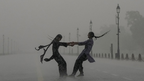 Gram it: Heavy monsoon showers kept Delhi on Red alert and the commuters battled traffic snarls for hours, on Monday. At Kartavya Path, however, some youngsters indulged in joie de vivre as they soaked up every moment of the downpour. Meanwhile, the India Meteorological Department (IMD) has issued a forecast of moderate rain and cloudy skies for today. (Photo: Arun Sharma/PTI)