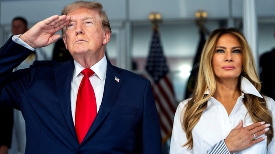 President Donald Trump with first lady Melania Trump during the National Anthem at the start of the Freedom 250 Grand Prix race. Doug Mills/Pool via REUTERS