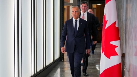 Canada’s Prime Minister Mark Carney walks to speak with the news media after he suspended trade negotiations with the United States, in Ottawa, Ontario, Canada August 22, 2026.  REUTERS/Chris Tanouye