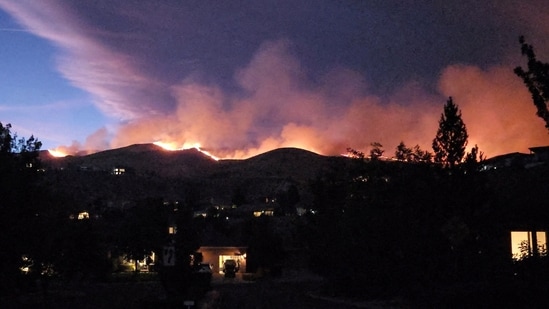 Smoke and flames rise from the Hawk fire in Reno, Nevada, U.S., August 22, 2026, in this screengrab from a video obtained from social media. (@SquintDev/via REUTERS)