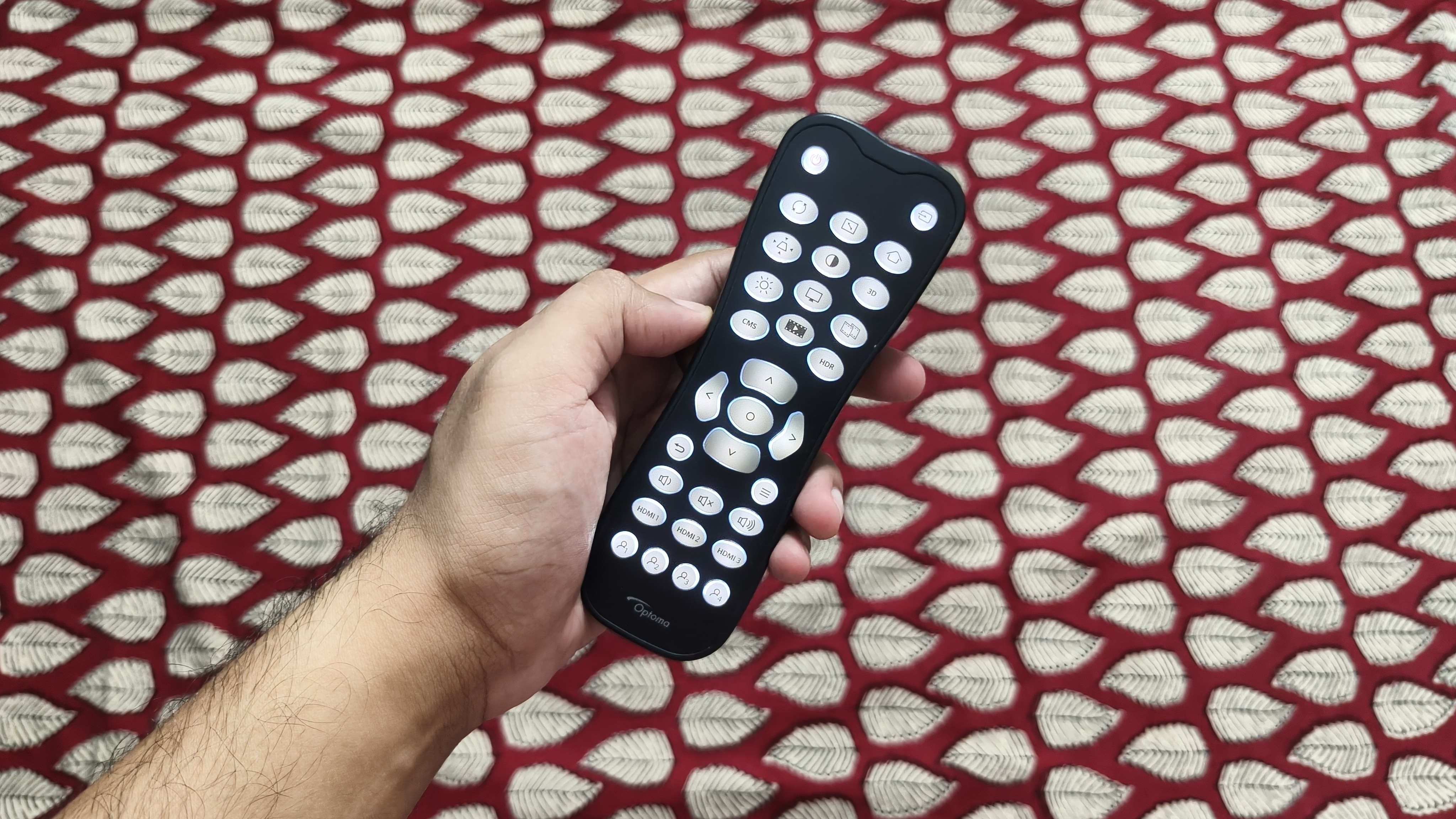 The Photon Beam PK52’s remote offers simple, backlit controls, but its lightweight build takes away from its premium feel. (Shubh Bhushan - )