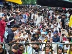 People sit at the protest site at Jantar Mantar supporting the Cockroach Janata Party's (CJP) protest. 