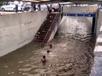 Children swim and play in a waterlogged area at Rajiv Chowk following continuous rainfall in Gurugram on Tuesday. (ANI Video Grab)