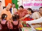 Chief minister Yogi Adityanath interacts with schoolchildren in Rae Bareli on Monday. (ANI PHOTO) Chief minister Yogi Adityanath interacts with schoolchildren in Rae Bareli on Monday. (ANI PHOTO)