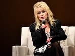 Dolly Parton and her honorary goddaughter Miley Cyrus share a moment together. (AP)
