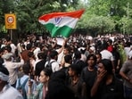 A supporter of India's Cockroach Janata Party (CJP) holds an Indian national flag at the protest in Jantar Mantar, Delhi(REUTERS)