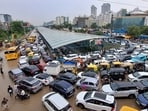 Vehicles remain stuck in a traffic jam on a waterlogged road following heavy rainfall, in Gurugram, Haryana.(PTI)