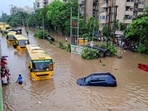 School buses wade through a waterlogged road following heavy rainfall, at Subhash Chowk in Gurugram, Haryana, Monday.(PTI)