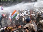 Police personnel use water cannons to disperse students protesting against alleged irregularities in recruitment examinations, near Dak Bungalow crossing, in Patna, Bihar.(PTI)