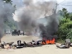A vehicle set on fire on a road in Taphou area amid reports of violence, in Senapati on Monday. 


