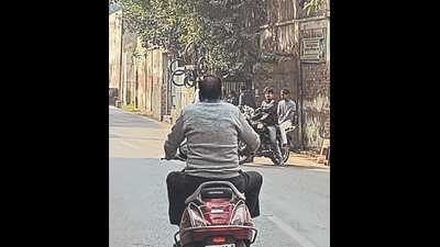 A grab from the video shot by the complainant showing Tara Chand Sharma riding a scooter in Agra (Sourced) A grab from the video shot by the complainant showing Tara Chand Sharma riding a scooter in Agra (Sourced)