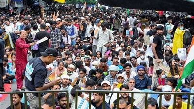 People sit at the protest site at Jantar Mantar supporting the Cockroach Janata Party's (CJP) protest. People sit at the protest site at Jantar Mantar supporting the Cockroach Janata Party's (CJP) protest.