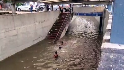 Children swim and play in a waterlogged area at Rajiv Chowk following continuous rainfall in Gurugram on Tuesday. (ANI Video Grab) Children swim and play in a waterlogged area at Rajiv Chowk following continuous rainfall in Gurugram on Tuesday. (ANI Video Grab)
