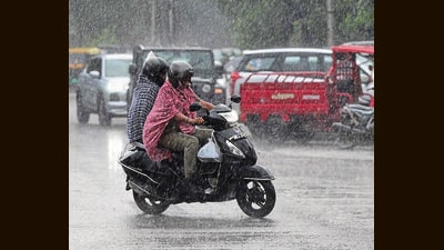 Commuters on their way during rain in Chandigarh on Tuesday. (Keshav Singh/HT)