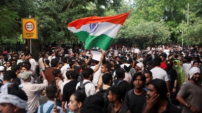 A supporter of India's Cockroach Janata Party (CJP) holds an Indian national flag at the protest in Jantar Mantar, Delhi (REUTERS)