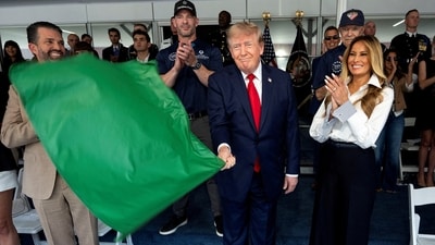 U.S. President Donald Trump waves the green flag to start the race with first lady Melania Trump at his side, during the Freedom 250 Grand Prix Race on the streets of Washington, D.C. (REUTERS)