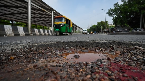 Traffic passes along a pothole-ridden Mathura road at Ashram Chowk during the monsoon in New Delhi, August 12, 2026.