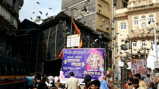 People gather at the site after a Ganesh idol of 'Bhuleshwaracha Raja' fell during its arrival ceremony on Saturday, in Bhuleshwar, Mumbai, Maharashtra, Sunday, Aug. 23, 2026.