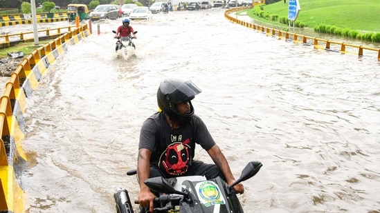 Delhi NCR weather LIVE: Commuters wade through knee-deep water in Delhi. (AFP)