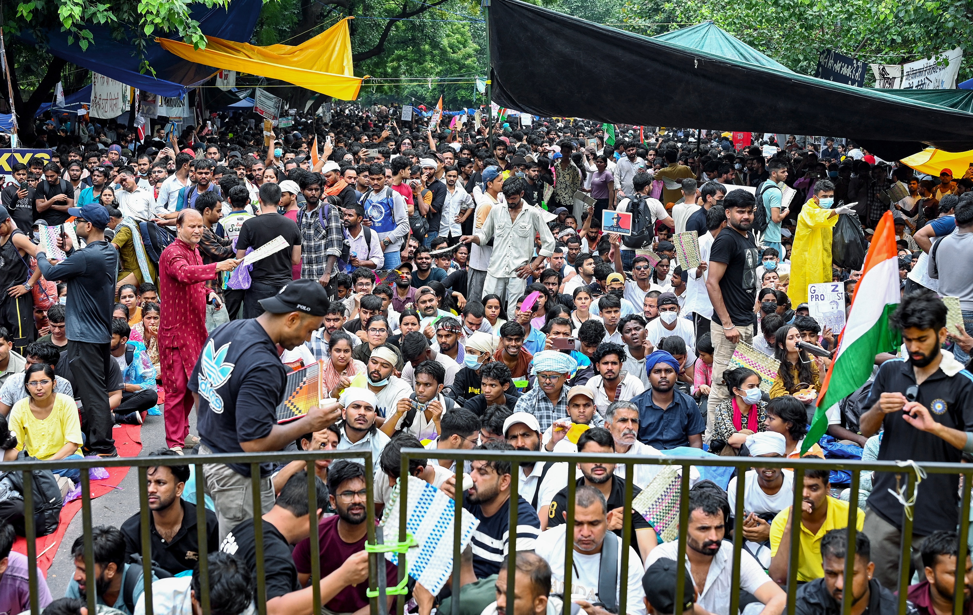 People sit at the protest site at Jantar Mantar during the CJP-led student protest over NEET paper leak. (PTI) People sit at the protest site at Jantar Mantar during the CJP-led student protest over NEET paper leak. (PTI)