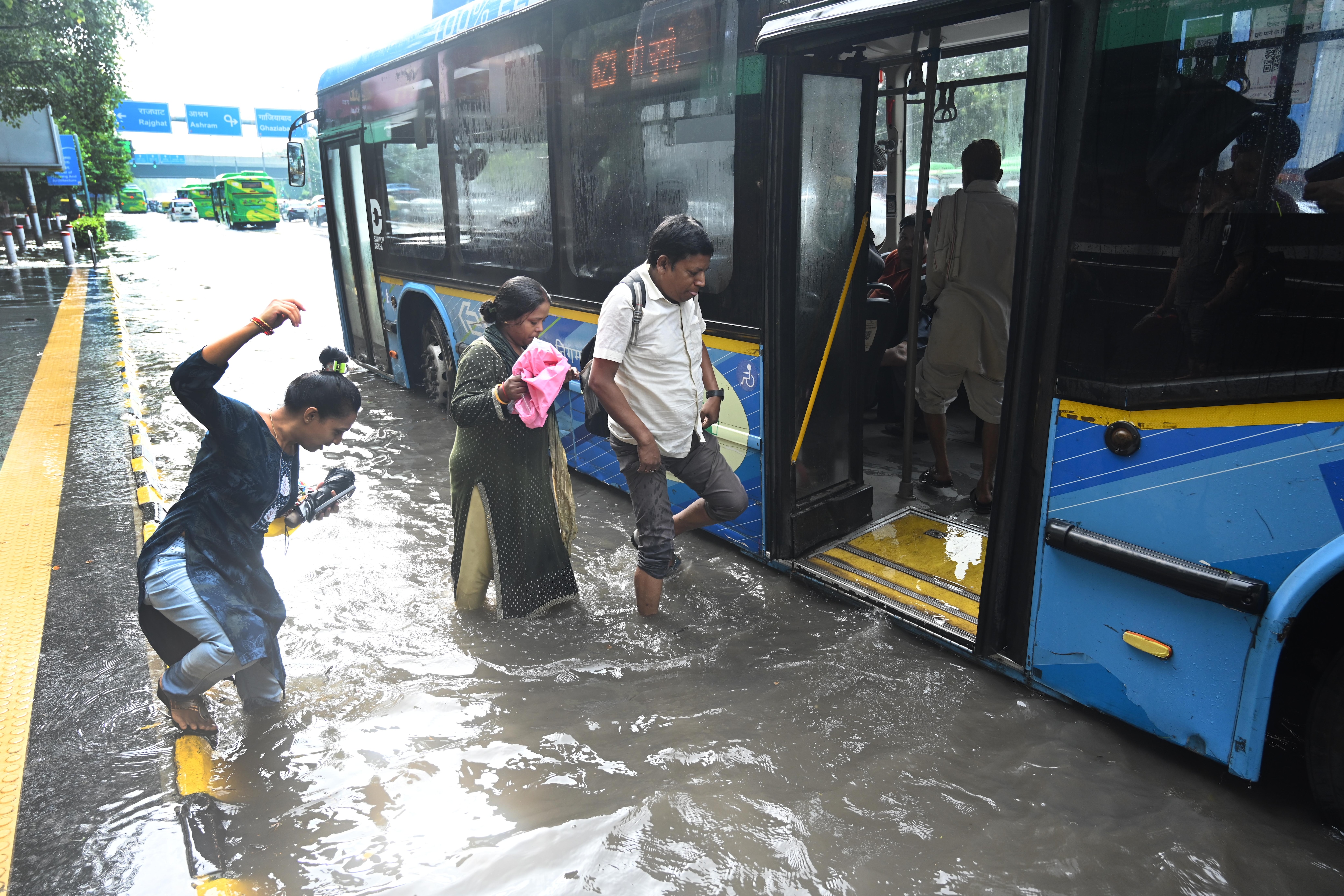 DTC bus passengers wade through deep water to board a bus on a waterlogged road along Vikas Marg, ITO following heavy rain in New Delhi, August 25, 2026. ( (Photo by Arvind Yadav/ Hindustan Times)) DTC bus passengers wade through deep water to board a bus on a waterlogged road along Vikas Marg, ITO following heavy rain in New Delhi, August 25, 2026. ( (Photo by Arvind Yadav/ Hindustan Times))