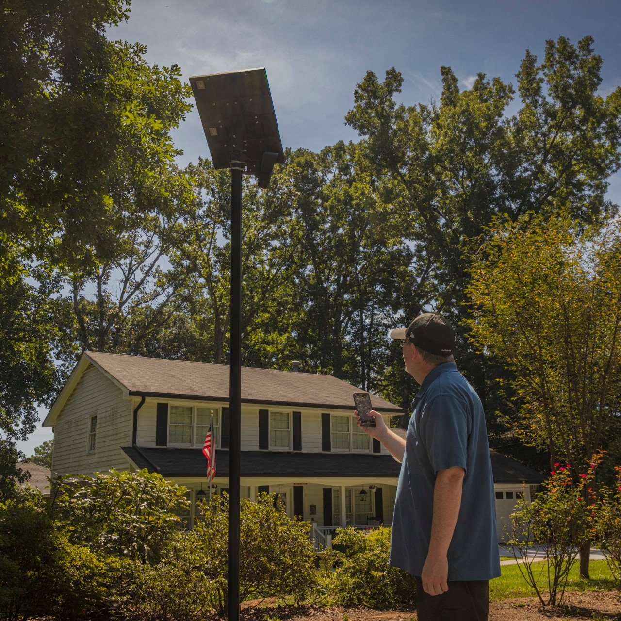Len Phillips uses his DeFlock app to map an automated license-plate reader at the entrance to a neighborhood in Dunwoody, Ga.