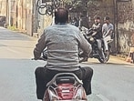 A grab from the video shot by the complainant showing Tara Chand Sharma riding a scooter in Agra (Sourced)