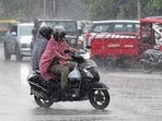 Commuters on their way during rain in Chandigarh on Tuesday. (Keshav Singh/HT)