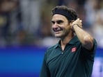 Roger Federer of Switzerland reacts while playing in the exhibition doubles match with John McEnroe against Andy Roddick and Andre Agassi
